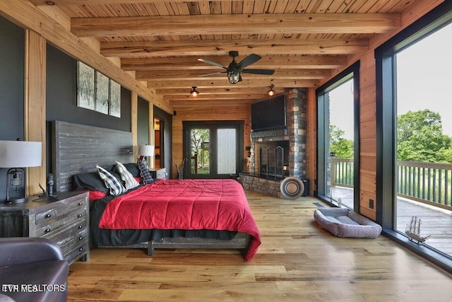 833 Duck Creek Rd, Sneedville, TN 37869 - bedroom featuring wood ceiling, access to outside, wood finished floors, beam ceiling, and a fireplace