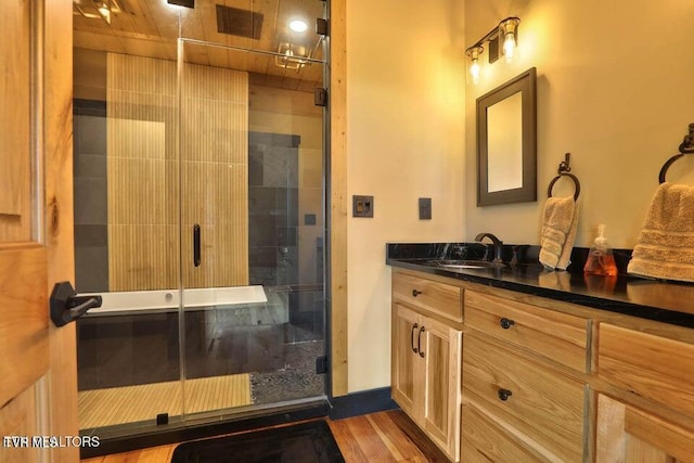 833 Duck Creek Rd, Sneedville, TN 37869 - bathroom with a shower stall, vanity, and wood finished floors
