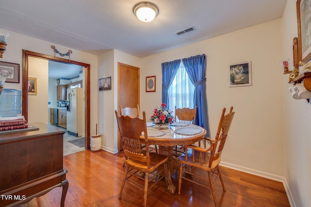 253 Fairford Ln, Blountville, TN 37617 - dining area with light wood-style floors, baseboards, and a textured ceiling