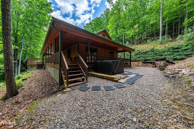 198 Gunbarrel Ln, Butler, TN 37640 - view of home's exterior featuring a hot tub, a wooden deck, and a wooded view