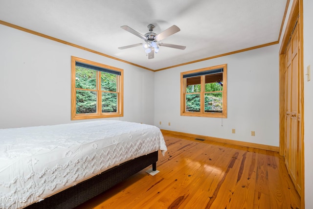 198 Gunbarrel Ln, Butler, TN 37640 - bedroom with crown molding, light wood finished floors, baseboards, and a ceiling fan