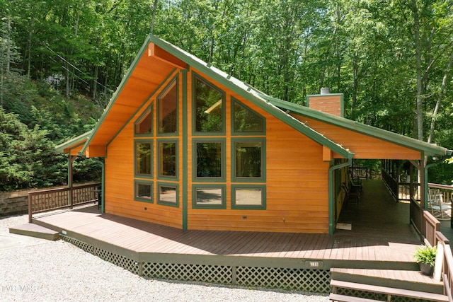 198 Gunbarrel Ln, Butler, TN 37640 - view of home's exterior with a chimney, a wooden deck, and a forest view