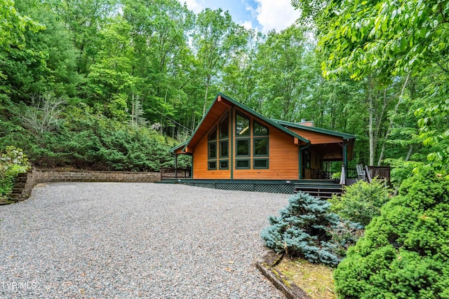 198 Gunbarrel Ln, Butler, TN 37640 - rear view of property featuring gravel driveway, a chimney, and a forest view