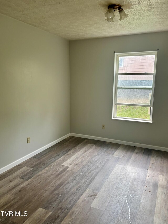 161 Jack Rival Way, Dungannon, VA 24245 - empty room featuring dark wood finished floors, baseboards, and a textured ceiling