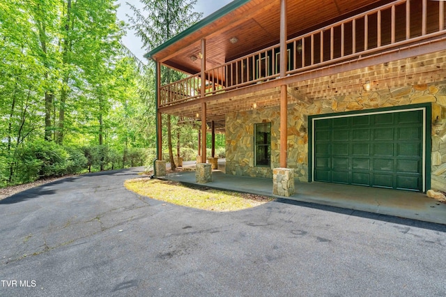 203 Bear Ridge Dr, Butler, TN 37640 - view of property exterior featuring stone siding, asphalt driveway, and a garage