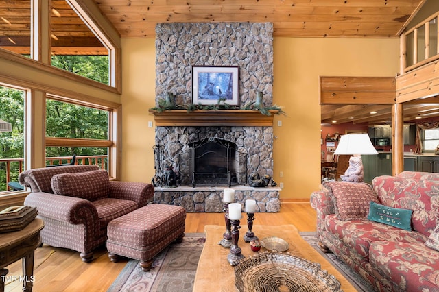 203 Bear Ridge Dr, Butler, TN 37640 - living area featuring wood finished floors, a high ceiling, a stone fireplace, and wooden ceiling