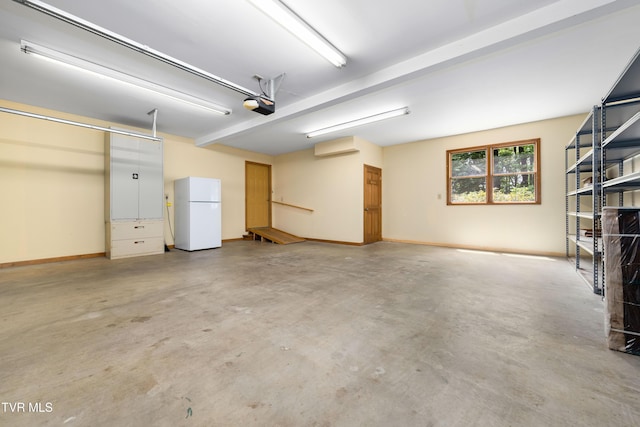 203 Bear Ridge Dr, Butler, TN 37640 - garage with freestanding refrigerator, a garage door opener, and baseboards