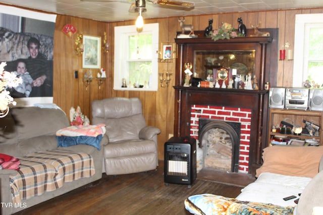 2967 Left Poor Valley Rd, Pennington Gap, VA 24277 - living room featuring wood walls, wood finished floors, a ceiling fan, and a fireplace