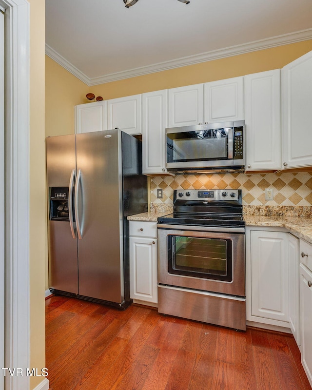 1101 E 8th Ave Unit 5, Johnson City, TN 37601 - kitchen with appliances with stainless steel finishes, ornamental molding, white cabinetry, and decorative backsplash