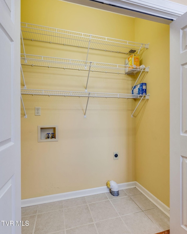 1101 E 8th Ave Unit 5, Johnson City, TN 37601 - washroom featuring electric dryer hookup, baseboards, light tile patterned floors, and hookup for a washing machine