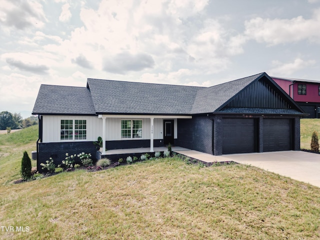 2166 Old Stage Rd, Tusculum, TN 37745 - view of front of property with covered porch, an attached garage, brick siding, and a front yard
