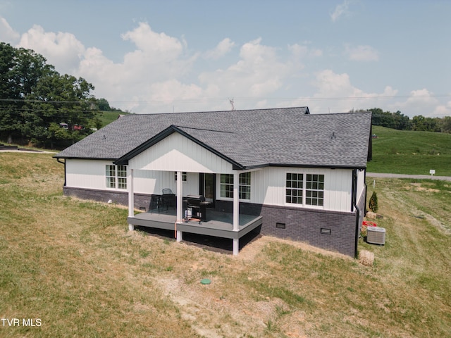 2166 Old Stage Rd, Tusculum, TN 37745 - rear view of property featuring central air condition unit, roof with shingles, a wooden deck, and a yard