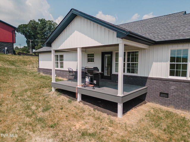 2166 Old Stage Rd, Tusculum, TN 37745 - back of property with brick siding, board and batten siding, a yard, and a wooden deck