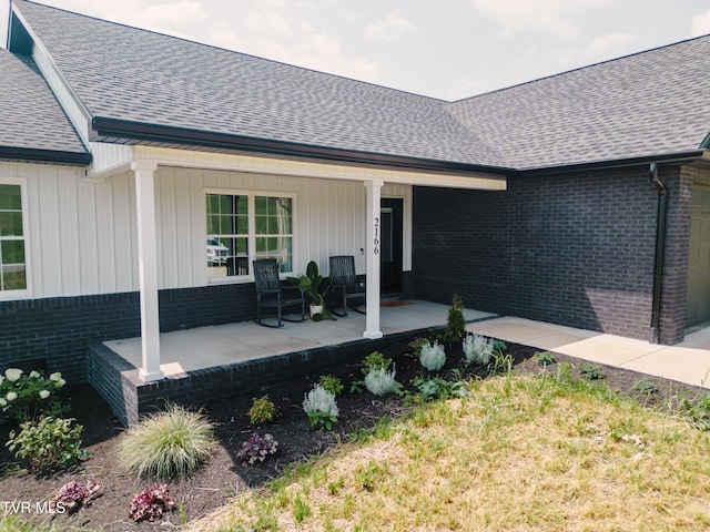 2166 Old Stage Rd, Tusculum, TN 37745 - entrance to property featuring a porch, a shingled roof, and brick siding