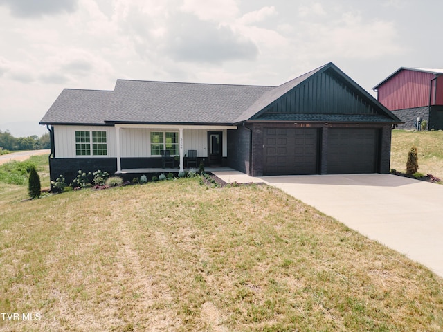 2166 Old Stage Rd, Tusculum, TN 37745 - view of front of home featuring an attached garage, a porch, board and batten siding, concrete driveway, and a front yard