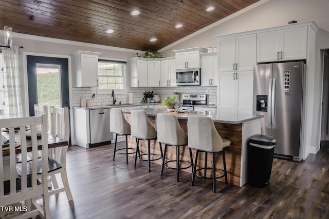 2166 Old Stage Rd, Tusculum, TN 37745 - kitchen with appliances with stainless steel finishes, wooden ceiling, a kitchen island, white cabinets, and decorative backsplash