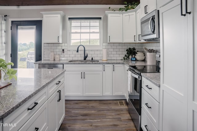 2166 Old Stage Rd, Tusculum, TN 37745 - kitchen featuring stainless steel appliances, a sink, white cabinets, and decorative backsplash
