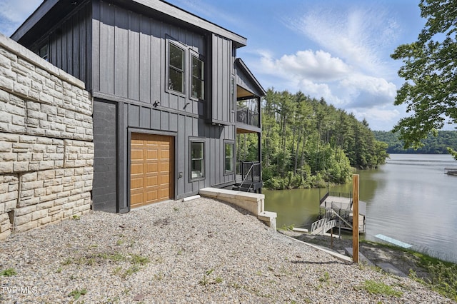 273 Campbell Rd, Butler, TN 37640 - view of side of property with a water view, board and batten siding, a dock, and stone siding