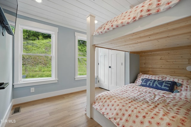 273 Campbell Rd, Butler, TN 37640 - bedroom with wood ceiling, multiple windows, wood finished floors, baseboards, and a closet