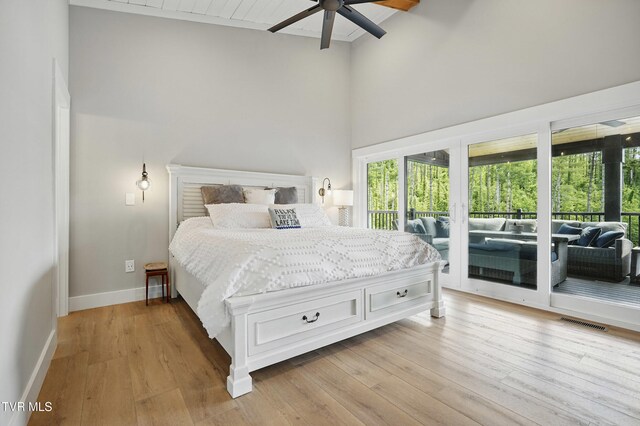 273 Campbell Rd, Butler, TN 37640 - bedroom featuring access to outside, multiple windows, high vaulted ceiling, light wood finished floors, and baseboards