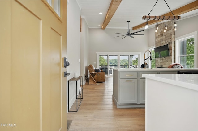 273 Campbell Rd, Butler, TN 37640 - kitchen featuring beam ceiling, open floor plan, a ceiling fan, light countertops, and light wood-style flooring
