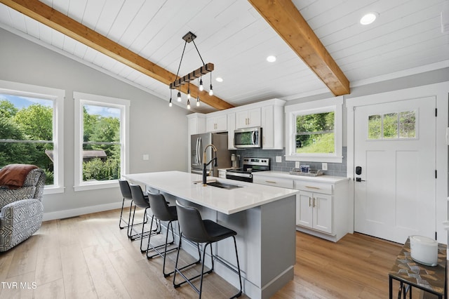 273 Campbell Rd, Butler, TN 37640 - kitchen featuring appliances with stainless steel finishes, a sink, recessed lighting, healthy amount of natural light, and a kitchen bar