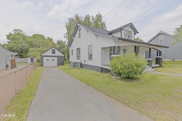 329 Clinch St, Kingsport, TN 37660 - view of front facade with an outdoor structure, a detached garage, central AC, and asphalt driveway