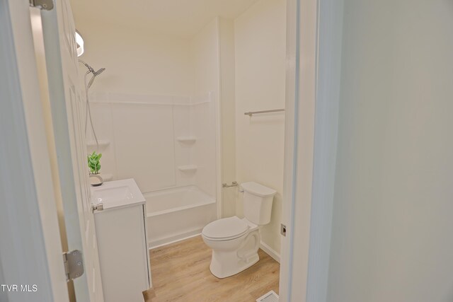 329 Clinch St, Kingsport, TN 37660 - full bath with wood finished floors, toilet, vanity, and shower / washtub combination