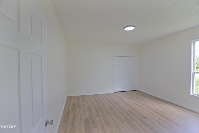 329 Clinch St, Kingsport, TN 37660 - spare room with light wood-type flooring, healthy amount of natural light, baseboards, and a textured ceiling
