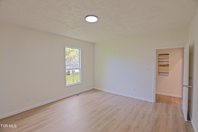 329 Clinch St, Kingsport, TN 37660 - unfurnished room featuring light wood-style flooring, a textured ceiling, and baseboards