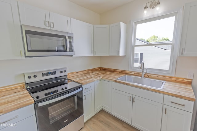 329 Clinch St, Kingsport, TN 37660 - kitchen featuring wooden counters, stainless steel appliances, a sink, and white cabinetry