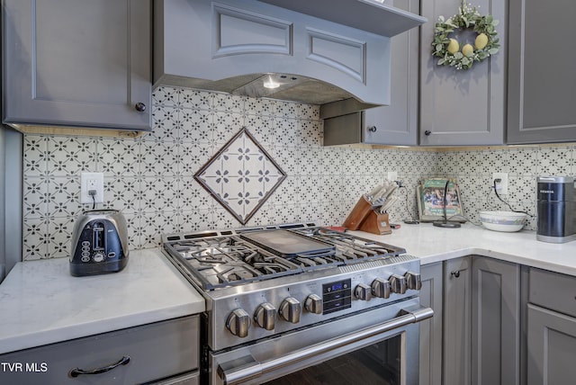 1 Celebration Ct, Johnson City, TN 37601 - kitchen featuring gas stove, gray cabinets, custom exhaust hood, tasteful backsplash, and light stone countertops