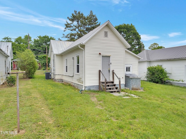 382 Texas Ave, Bristol, VA 24201 - back of property with entry steps, a lawn, central air condition unit, and metal roof