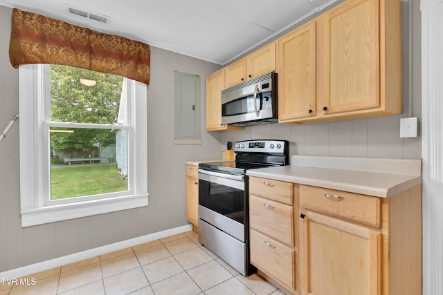 382 Texas Ave, Bristol, VA 24201 - kitchen featuring appliances with stainless steel finishes, light brown cabinets, baseboards, light countertops, and plenty of natural light