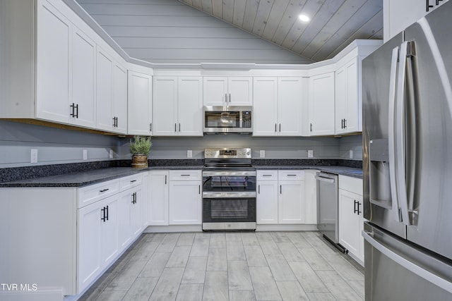 403 Catawba St, Erwin, TN 37650 - kitchen with stainless steel appliances, vaulted ceiling, wooden ceiling, white cabinets, and light wood-type flooring