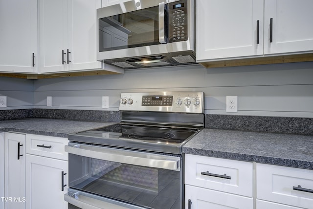 403 Catawba St, Erwin, TN 37650 - kitchen with stainless steel appliances, dark countertops, and white cabinets