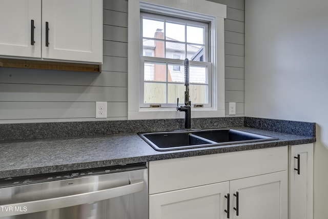 403 Catawba St, Erwin, TN 37650 - kitchen with stainless steel dishwasher, dark countertops, a sink, and white cabinets