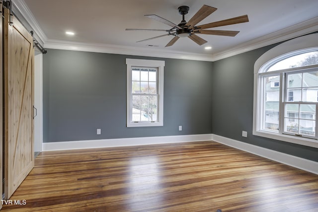 403 Catawba St, Erwin, TN 37650 - spare room featuring a barn door, wood finished floors, ornamental molding, ceiling fan, and baseboards
