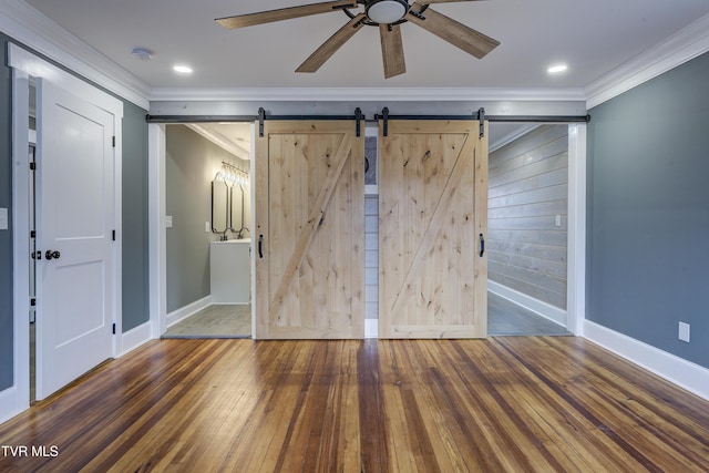403 Catawba St, Erwin, TN 37650 - unfurnished bedroom featuring a barn door, ornamental molding, hardwood / wood-style floors, baseboards, and ensuite bath