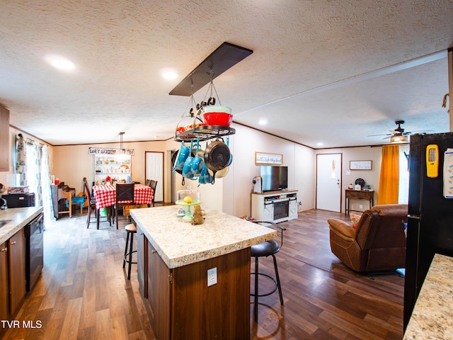 1029 Red Bud Ln, Rogersville, TN 37857 - kitchen featuring a breakfast bar area, dark wood-style floors, light countertops, open floor plan, and a textured ceiling