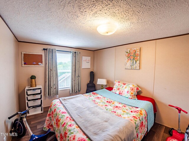 1029 Red Bud Ln, Rogersville, TN 37857 - bedroom with a textured ceiling, wood finished floors, and crown molding