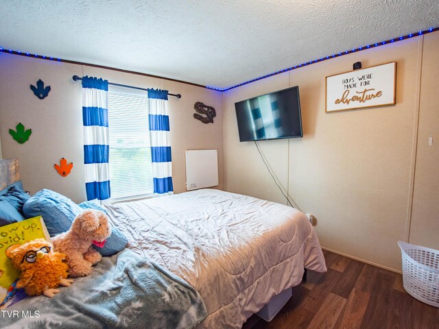 1029 Red Bud Ln, Rogersville, TN 37857 - bedroom with wood finished floors, a textured ceiling, and baseboards