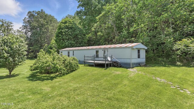 438 Horace Dillow Rd, Limestone, TN 37681 - back of property featuring a lawn and metal roof