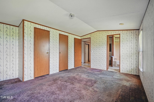 438 Horace Dillow Rd, Limestone, TN 37681 - unfurnished bedroom with wallpapered walls, ornamental molding, lofted ceiling, carpet floors, and multiple closets