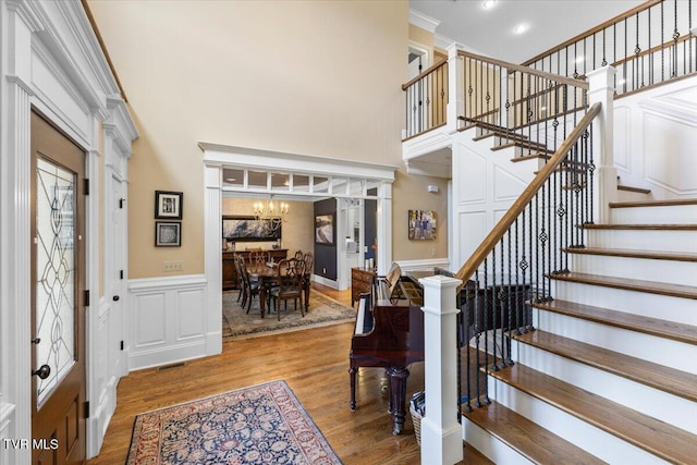 114 Highland Gate Dr, Johnson City, TN 37615 - foyer with a high ceiling, a chandelier, wood finished floors, stairs, and a wainscoted wall