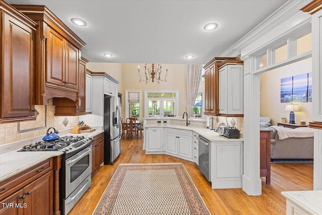 114 Highland Gate Dr, Johnson City, TN 37615 - kitchen with stainless steel appliances, a chandelier, light wood-style floors, backsplash, and recessed lighting