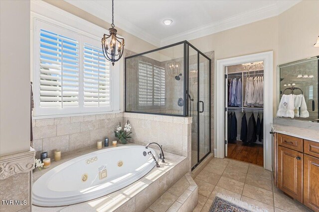 114 Highland Gate Dr, Johnson City, TN 37615 - full bathroom with a chandelier, a stall shower, vanity, a whirlpool tub, and a spacious closet