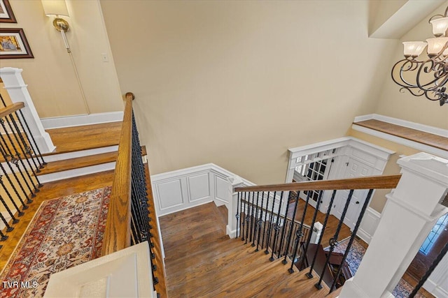 114 Highland Gate Dr, Johnson City, TN 37615 - stairway featuring wood finished floors, a chandelier, a decorative wall, and a wainscoted wall