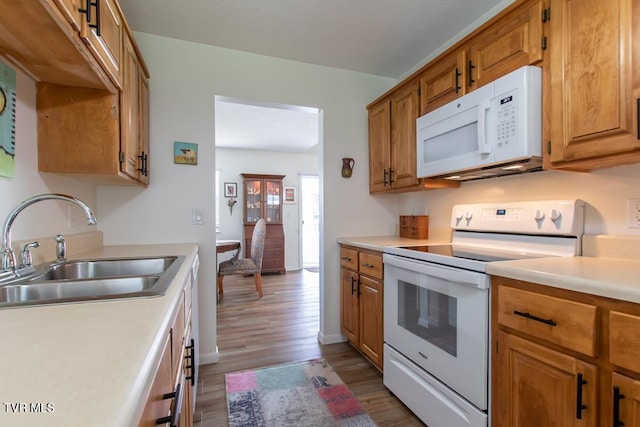 14227 Wellbridge Dr, Meadowview, VA 24361 - kitchen featuring white appliances, a sink, light wood finished floors, light countertops, and brown cabinetry