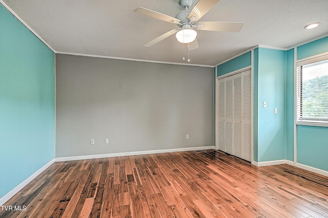 28 Kingsbridge St, Bristol, TN 37620 - unfurnished bedroom with wood-type flooring, ornamental molding, a closet, a textured ceiling, and baseboards